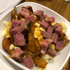 Papas poutine topped with smoked meat