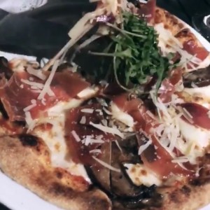 pizza con prosciutto, arrugula y hongos de portobello 